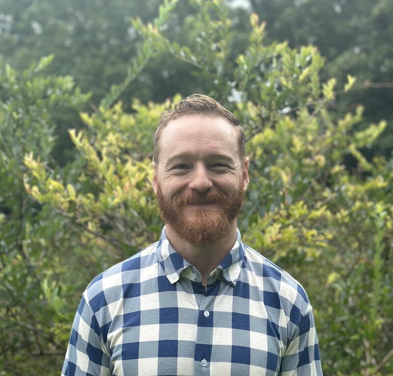 Matt Mueller, founder of Clear Springs Web Design, in a blue checked shirt outdoors